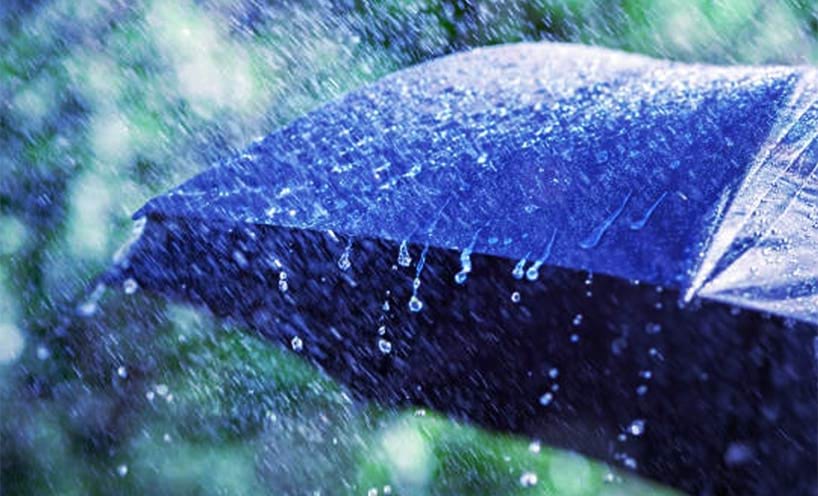Blue umbrella in a downpour of rainy weather